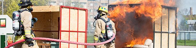Firemen Training With Hoses and Fire